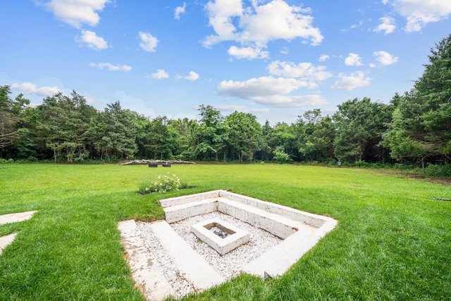 1240 John Windrow Rd, Eagleville, TN 37060 - view of grassy yard with a fire pit and a forest view