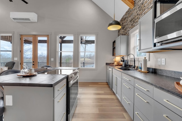 44 Hasty Hill Rd, Lynchburg, TN 37352 - kitchen with appliances with stainless steel finishes, a sink, a wall mounted air conditioner, light wood-style flooring, and high vaulted ceiling