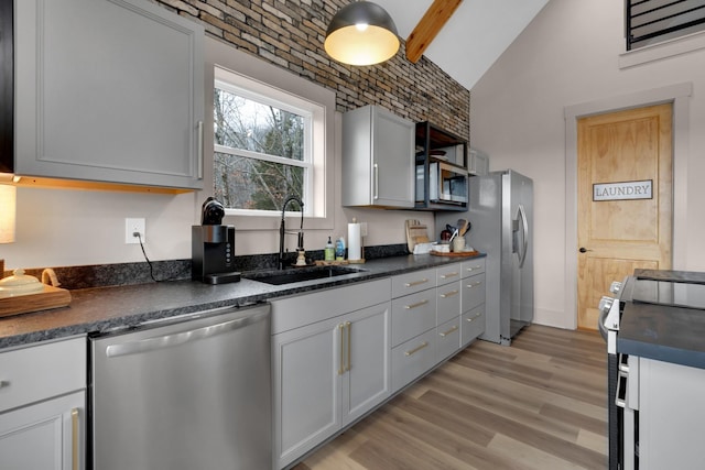 44 Hasty Hill Rd, Lynchburg, TN 37352 - kitchen with stainless steel appliances, a sink, dark countertops, lofted ceiling, and light wood finished floors