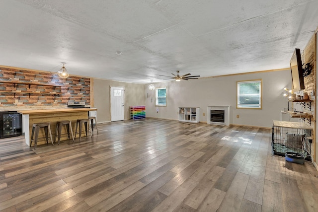 9780 S Lick Creek Rd SW, Lyles, TN 37098 - living area with beverage cooler, a ceiling fan, hardwood / wood-style floors, a fireplace, and baseboards