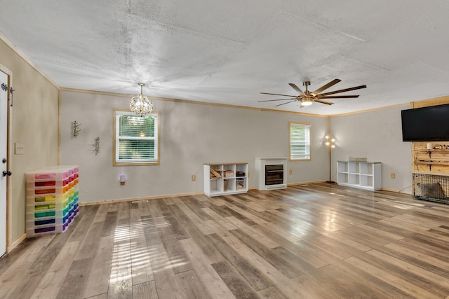 9780 S Lick Creek Rd SW, Lyles, TN 37098 - unfurnished living room featuring healthy amount of natural light, a fireplace, crown molding, a textured ceiling, and wood finished floors