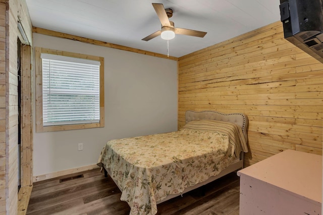9780 S Lick Creek Rd SW, Lyles, TN 37098 - bedroom with dark wood-style floors, wood walls, a ceiling fan, and baseboards