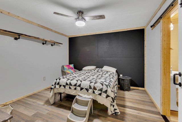 9780 S Lick Creek Rd SW, Lyles, TN 37098 - bedroom with wood finished floors, baseboards, and ceiling fan