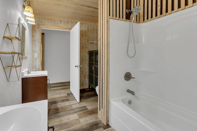 9780 S Lick Creek Rd SW, Lyles, TN 37098 - full bath with vanity, washtub / shower combination, and wood finished floors