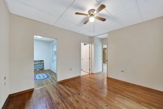 943 Old Ccc Rd, Sewanee, TN 37375 - spare room with wood finished floors, a ceiling fan, a paneled ceiling, and baseboards