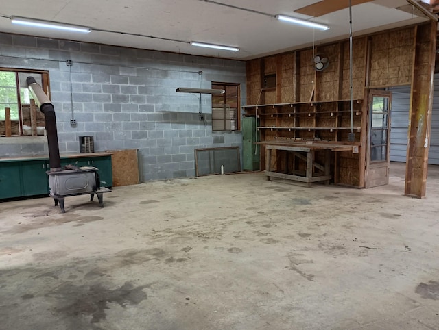 943 Old Ccc Rd, Sewanee, TN 37375 - miscellaneous room with a wood stove, unfinished concrete floors, and concrete block wall