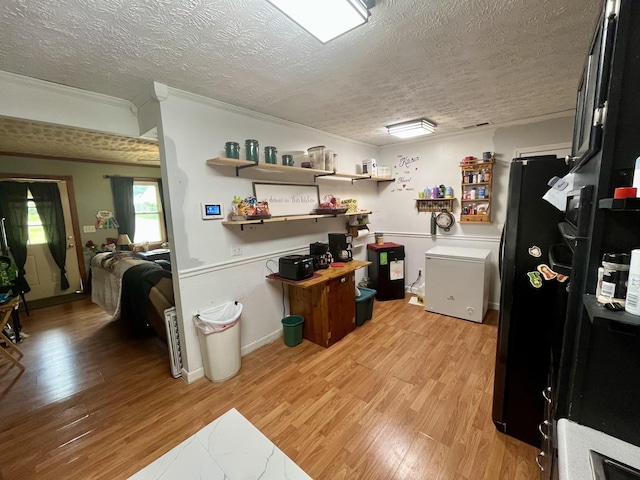 505 Wesley Ave, Nashville, TN 37207 - kitchen with a textured ceiling, light wood finished floors, freestanding refrigerator, light countertops, and fridge