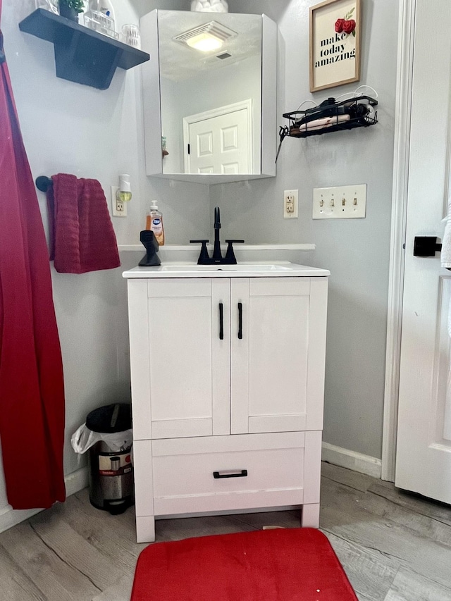 505 Wesley Ave, Nashville, TN 37207 - bathroom featuring vanity, wood finished floors, and baseboards