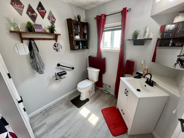 505 Wesley Ave, Nashville, TN 37207 - bathroom with wood finished floors, vanity, toilet, and baseboards