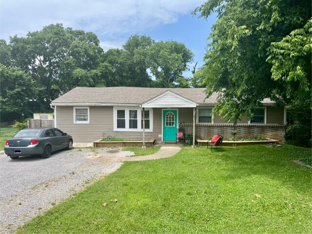 505 Wesley Ave, Nashville, TN 37207 - ranch-style home with a front lawn, a shingled roof, and driveway
