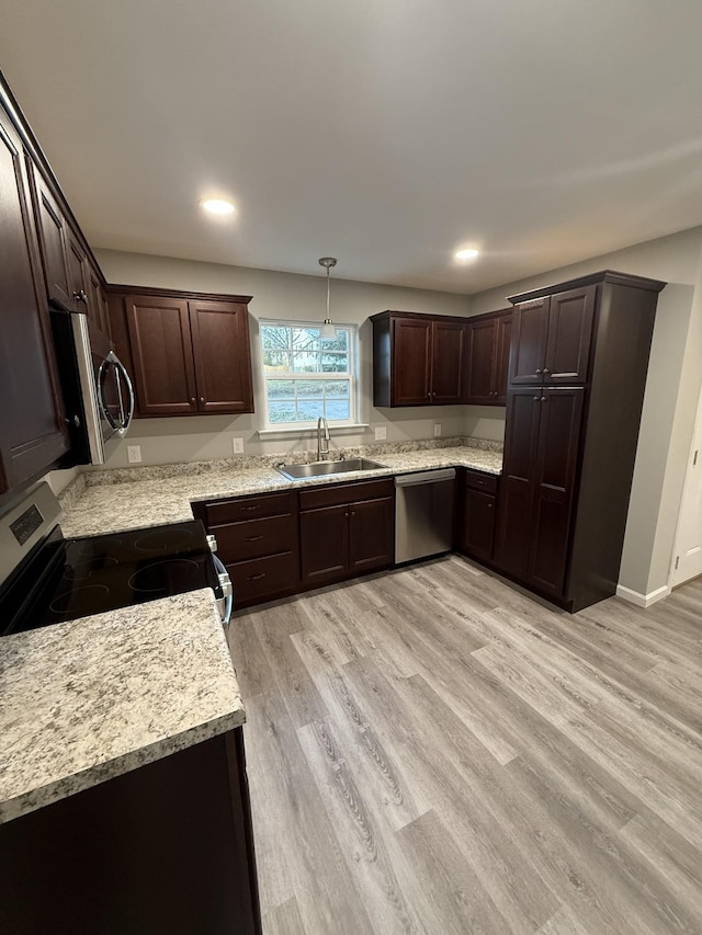 507 Locust St, Mcminnville, TN 37110 - kitchen with stainless steel appliances, a sink, light countertops, dark brown cabinetry, and light wood-style flooring