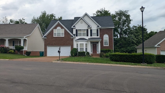 1710 Tellico Dr, Thompsons Station, TN 37179 - traditional-style house featuring concrete driveway, brick siding, and an attached garage