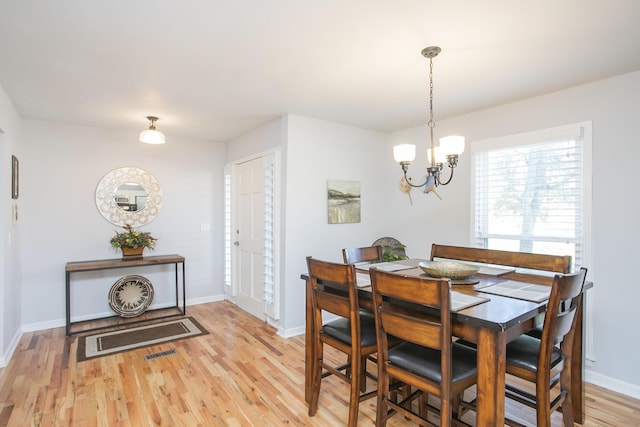321 Amherst Dr, Murfreesboro, TN 37128 - dining area featuring a chandelier, light wood-style floors, and baseboards