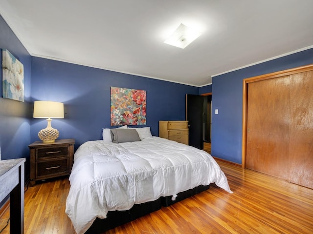 189 Washington Ave, Camden, TN 38320 - bedroom featuring wood finished floors, ornamental molding, and a closet