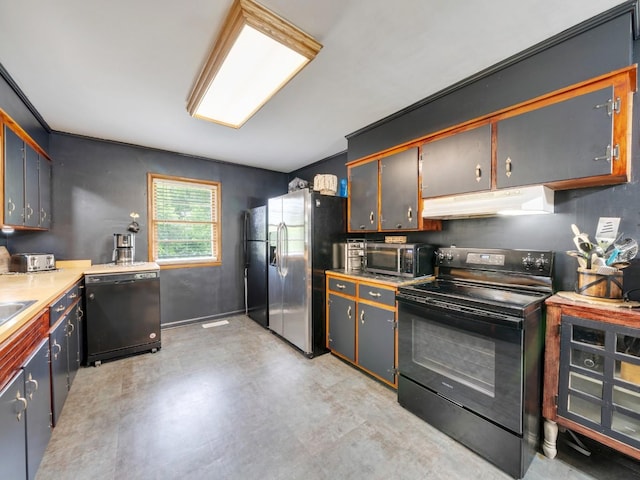189 Washington Ave, Camden, TN 38320 - kitchen featuring black appliances, under cabinet range hood, light countertops, and light flooring
