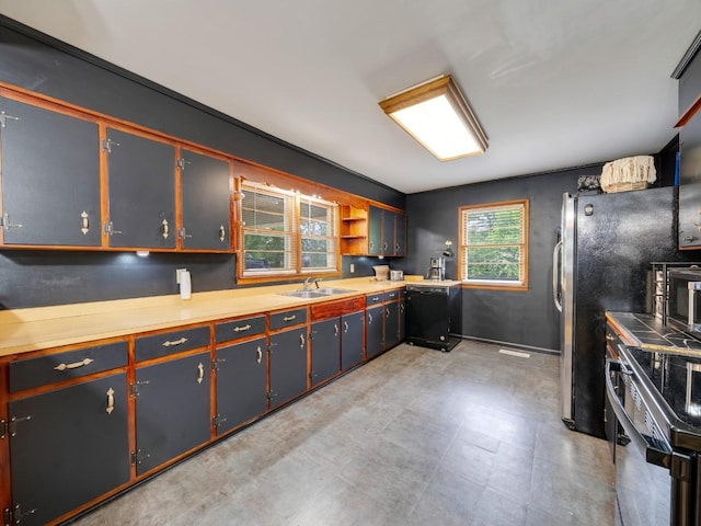 189 Washington Ave, Camden, TN 38320 - kitchen featuring range with electric stovetop, dishwasher, a sink, light floors, and light countertops