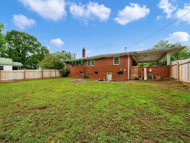 189 Washington Ave, Camden, TN 38320 - back of house with a chimney, brick siding, and central AC unit