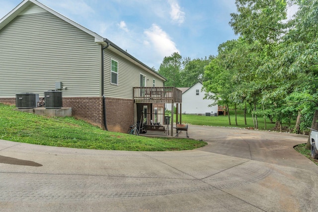 4001 S Windsor Ct, Springfield, TN 37172 - view of home's exterior with central air condition unit, a deck, a lawn, and brick siding