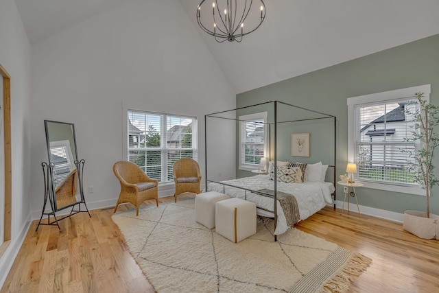 609 Dallas Ct, Murfreesboro, TN 37130 - bedroom with high vaulted ceiling, a chandelier, multiple windows, wood finished floors, and baseboards