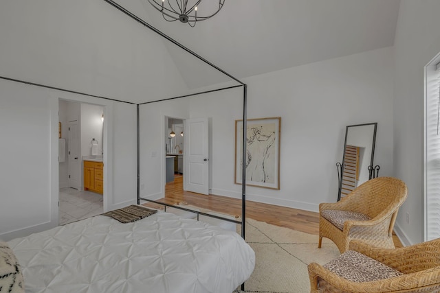 609 Dallas Ct, Murfreesboro, TN 37130 - bedroom with a chandelier, baseboards, light wood finished floors, ensuite bath, and a towering ceiling