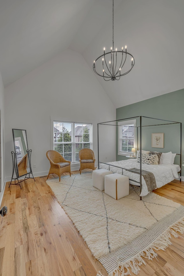 609 Dallas Ct, Murfreesboro, TN 37130 - bedroom featuring high vaulted ceiling, a chandelier, wood finished floors, and baseboards