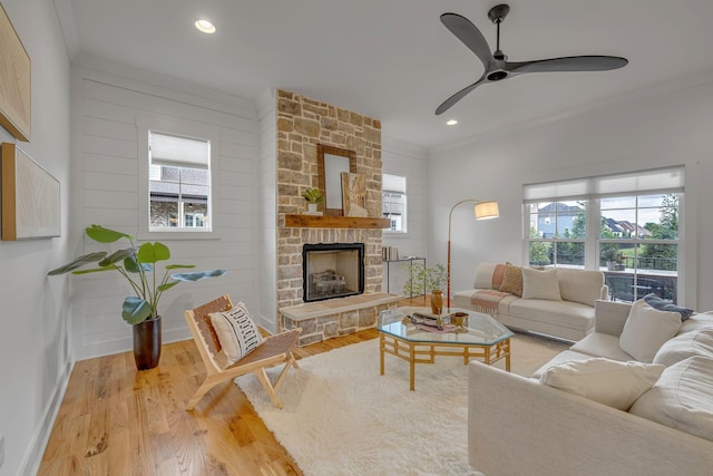 609 Dallas Ct, Murfreesboro, TN 37130 - living area featuring wood finished floors, baseboards, crown molding, a ceiling fan, and a stone fireplace