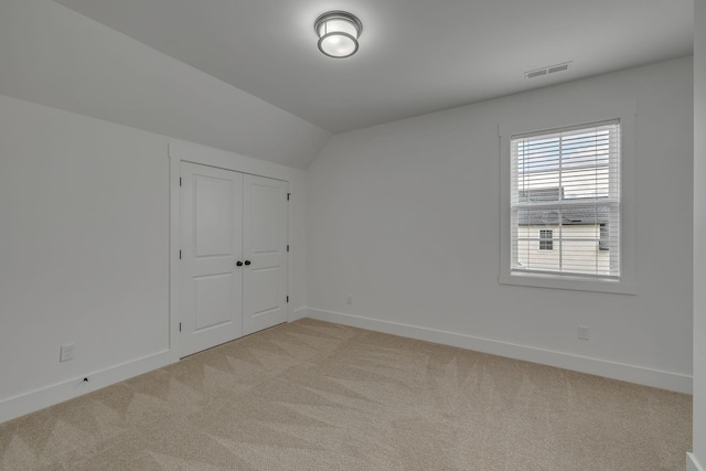 609 Dallas Ct, Murfreesboro, TN 37130 - unfurnished bedroom featuring vaulted ceiling, light colored carpet, baseboards, and a closet