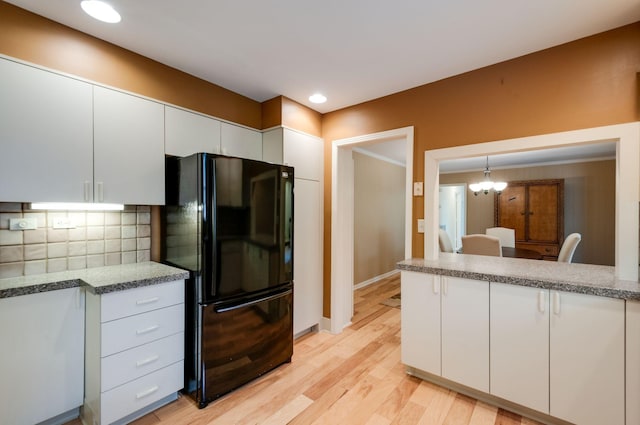 6307 Park Ln, Nashville, TN 37205 - kitchen featuring freestanding refrigerator, white cabinetry, decorative backsplash, light wood finished floors, and baseboards
