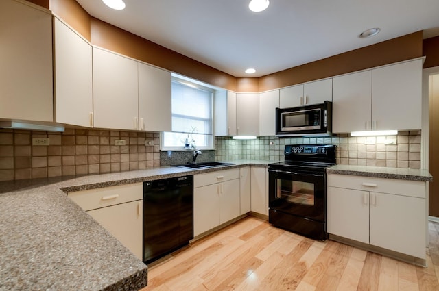 6307 Park Ln, Nashville, TN 37205 - kitchen with black appliances, a sink, light wood-type flooring, white cabinets, and recessed lighting