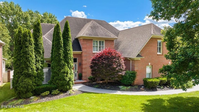 9106 Farrell Park Ln, Knoxville, TN 37922 - view of front of house with a front yard, brick siding, and a shingled roof