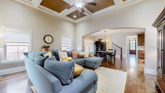 1303 Reynard Dr, Gallatin, TN 37066 - living area with arched walkways, a chandelier, a towering ceiling, baseboards, and a ceiling fan