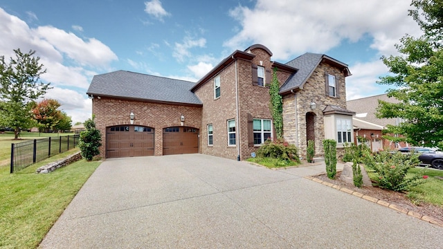 1303 Reynard Dr, Gallatin, TN 37066 - view of side of property with an attached garage, driveway, a shingled roof, brick siding, and stone siding