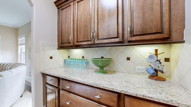 1303 Reynard Dr, Gallatin, TN 37066 - kitchen featuring arched walkways, ornamental molding, light stone countertops, and tasteful backsplash