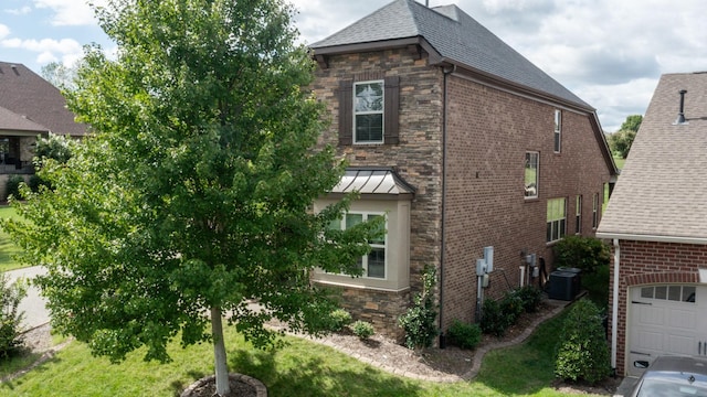 1303 Reynard Dr, Gallatin, TN 37066 - view of side of home featuring stone siding, central AC, brick siding, and a shingled roof