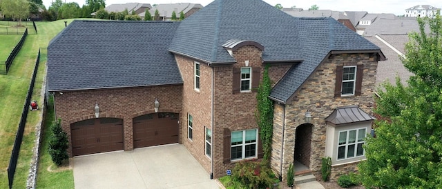 1303 Reynard Dr, Gallatin, TN 37066 - view of front of house featuring concrete driveway, a shingled roof, brick siding, stone siding, and an attached garage