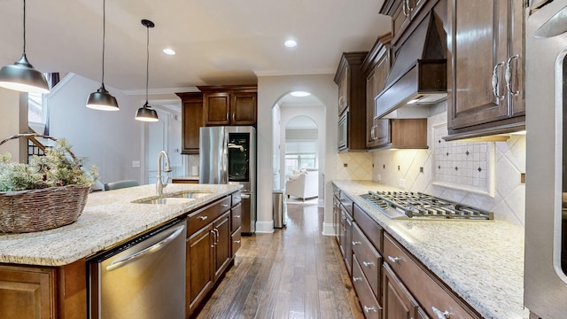 1303 Reynard Dr, Gallatin, TN 37066 - kitchen featuring stainless steel appliances, a sink, custom exhaust hood, arched walkways, and tasteful backsplash