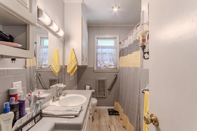 262 Purdy Rd, Selmer, TN 38375 - full bathroom with tile walls, toilet, ornamental molding, vanity, and wainscoting