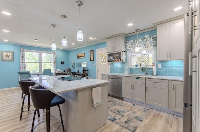 262 Purdy Rd, Selmer, TN 38375 - kitchen with dishwasher, a sink, a kitchen island with sink, light wood-type flooring, and decorative backsplash