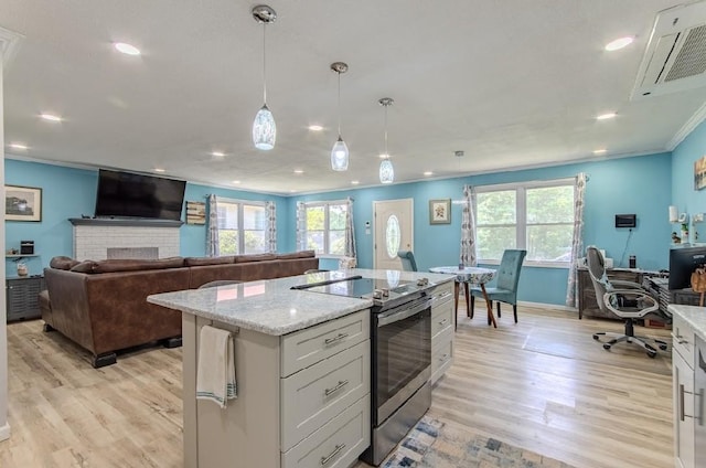 262 Purdy Rd, Selmer, TN 38375 - kitchen featuring stainless steel range with electric stovetop, light wood-style flooring, ornamental molding, hanging light fixtures, and light stone counters