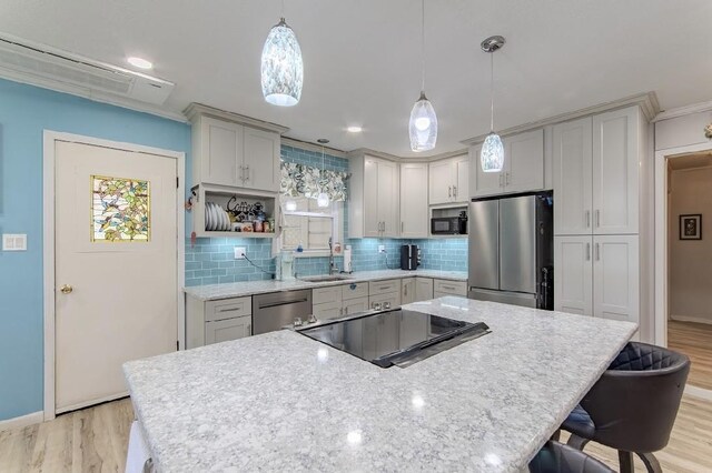 262 Purdy Rd, Selmer, TN 38375 - kitchen with stainless steel appliances, light wood-style floors, backsplash, baseboards, and crown molding