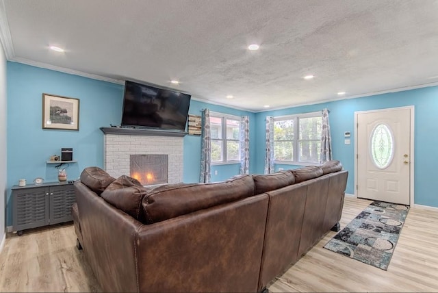 262 Purdy Rd, Selmer, TN 38375 - living area featuring light wood-style floors, crown molding, a fireplace, recessed lighting, and a textured ceiling