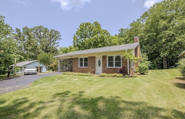 262 Purdy Rd, Selmer, TN 38375 - view of front of home with a chimney, a front lawn, brick siding, and asphalt driveway