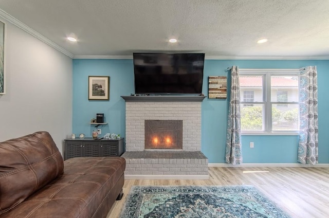 262 Purdy Rd, Selmer, TN 38375 - living room with wood finished floors, crown molding, a brick fireplace, a textured ceiling, and baseboards