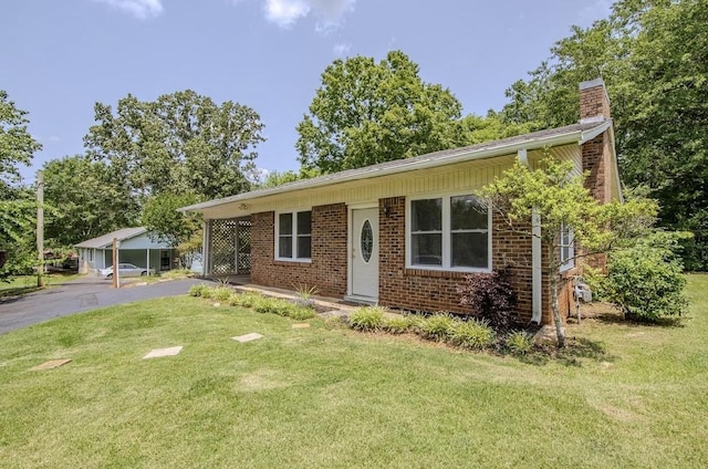 262 Purdy Rd, Selmer, TN 38375 - ranch-style home featuring a front lawn, a chimney, brick siding, and driveway