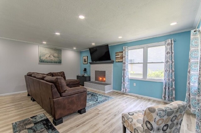 262 Purdy Rd, Selmer, TN 38375 - living area with ornamental molding, a brick fireplace, baseboards, wood finished floors, and a textured ceiling