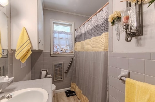 262 Purdy Rd, Selmer, TN 38375 - bathroom featuring tile walls, heating unit, ornamental molding, wainscoting, and toilet
