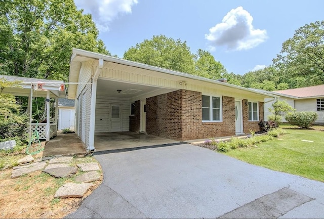 262 Purdy Rd, Selmer, TN 38375 - ranch-style house featuring brick siding, driveway, a carport, and a front yard