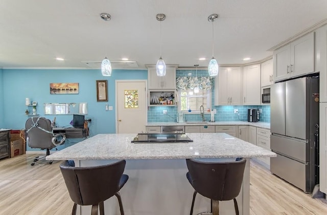 262 Purdy Rd, Selmer, TN 38375 - kitchen featuring stainless steel appliances, a breakfast bar area, backsplash, a center island, and recessed lighting