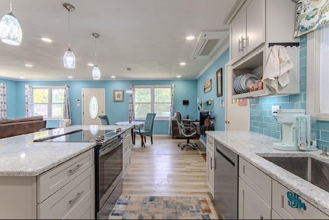 262 Purdy Rd, Selmer, TN 38375 - kitchen featuring stainless steel appliances, light wood finished floors, open floor plan, baseboards, and light stone counters