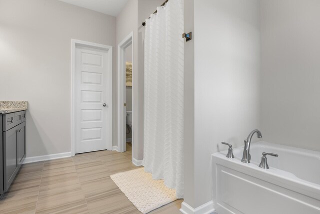 6787 Dharma Loop, Chattanooga, TN 37412 - bathroom with a garden tub, vanity, toilet, and baseboards